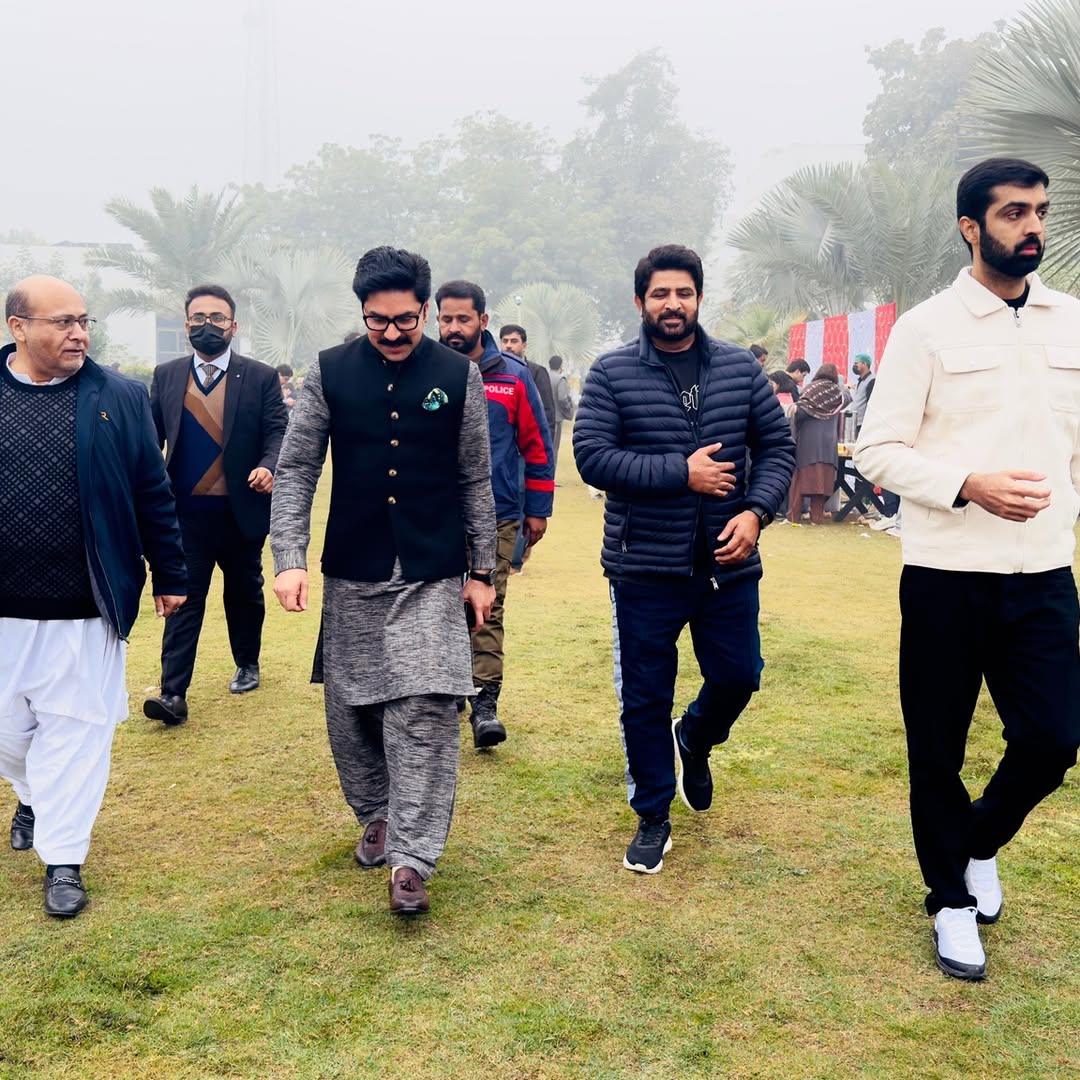 Members walking together on the lawn at Vehari Gymkhana