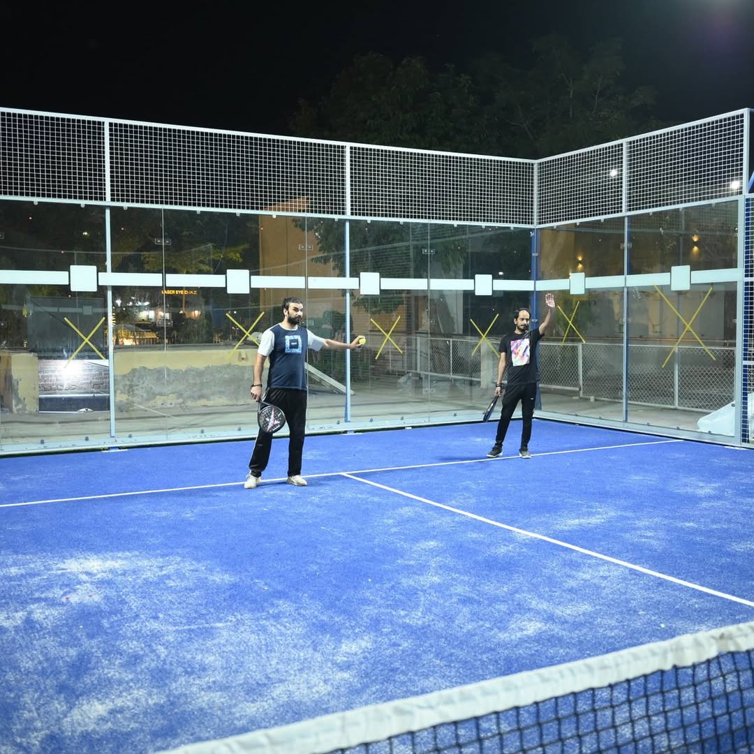 Two members playing on the floodlit padel court at Vehari Gymkhana