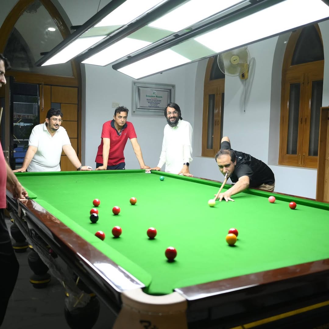 Members playing snooker in the club's billiards room